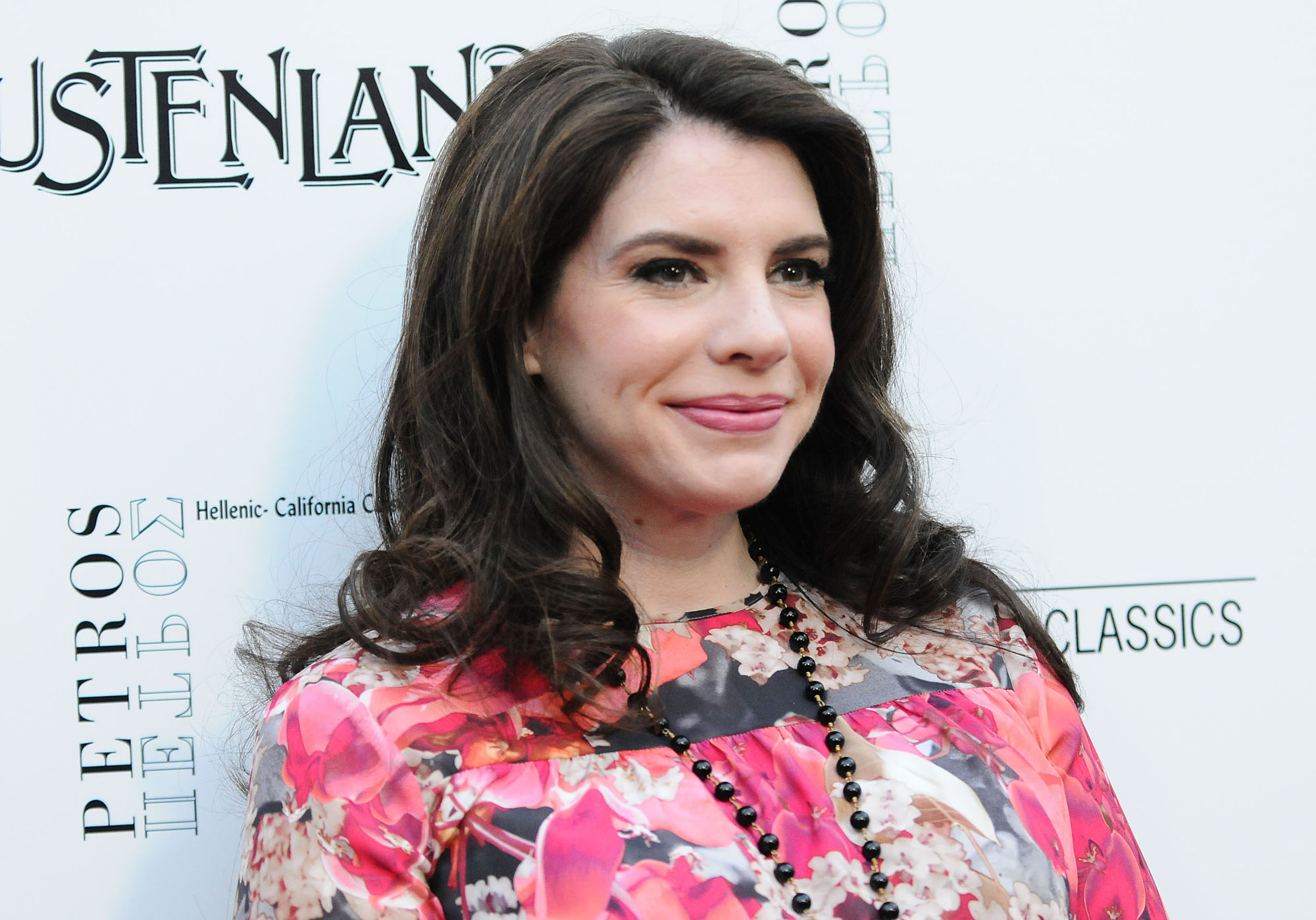 Twilight author Stephenie Meyer wearing a floral dress and black beads around her neck