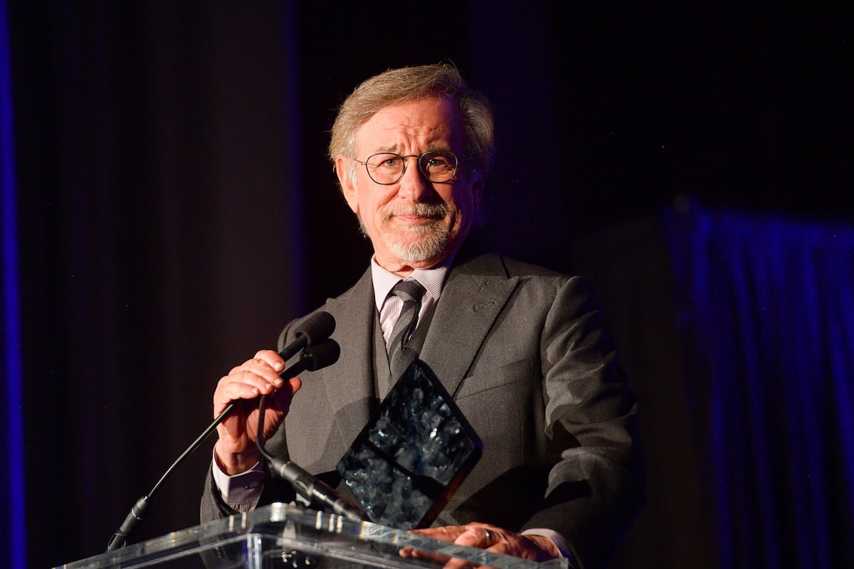Steven Spielberg wears a suit and speaks onstage