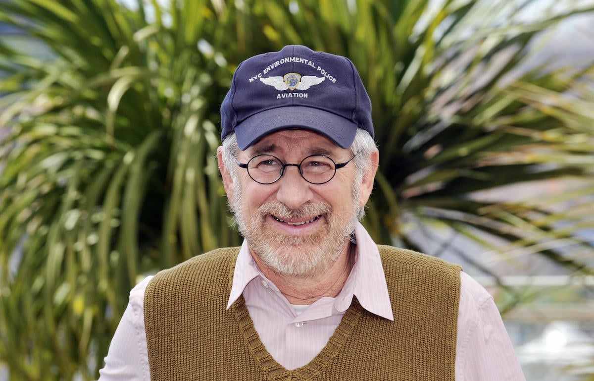 Steven Spielberg wears a hat and smiles
