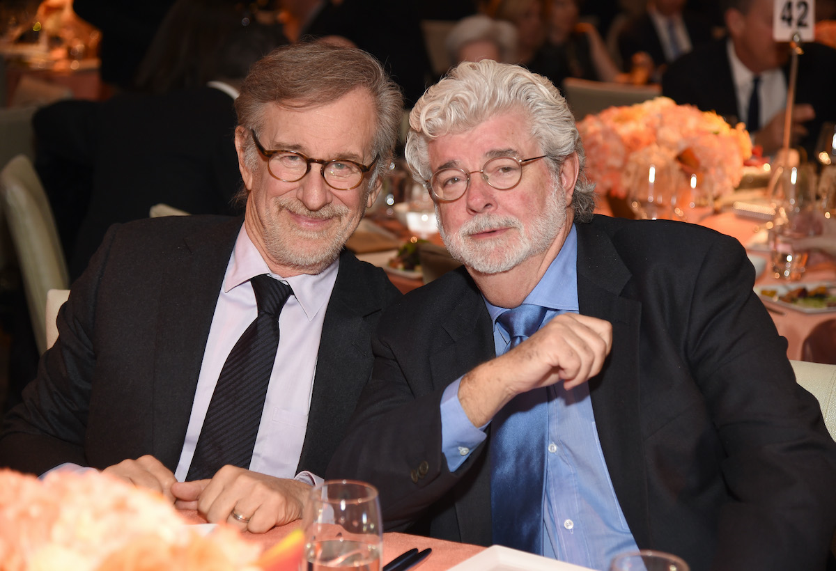 Steven Spielberg and George Lucas wear suits and pose