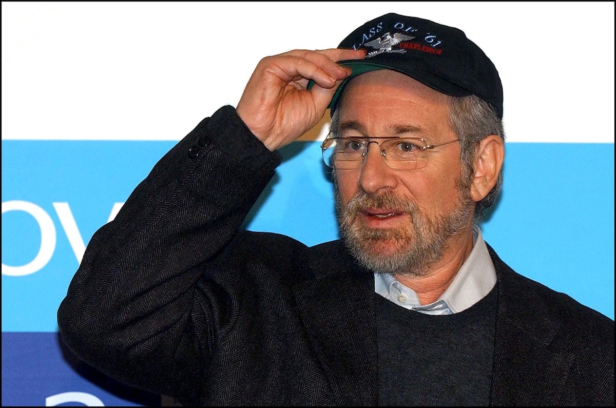 Steven Spielberg holds up his hat and looks onto the horizon