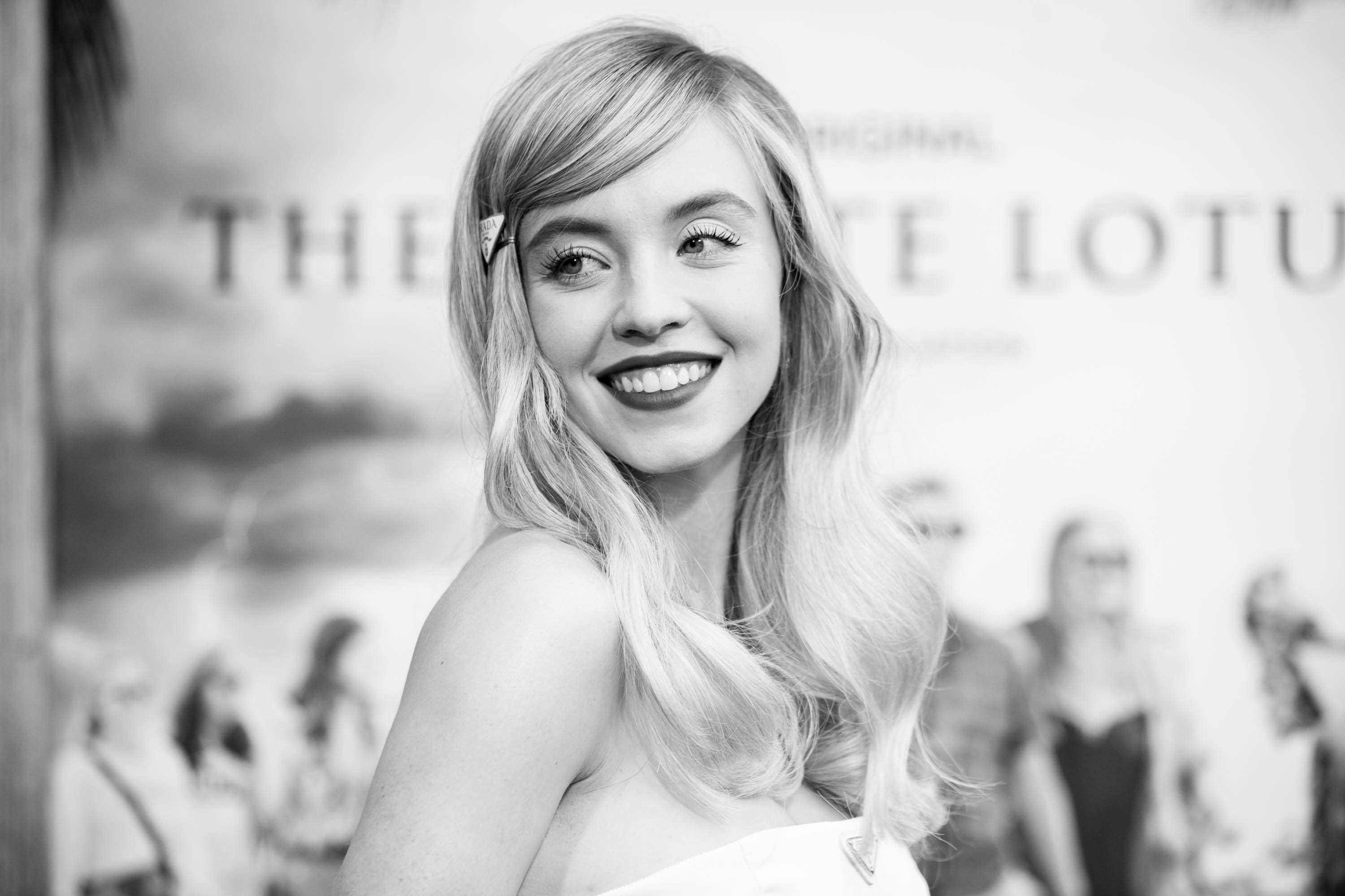 The White Lotus cast member Sydney Sweeney wears a white dress to the premiere of the show