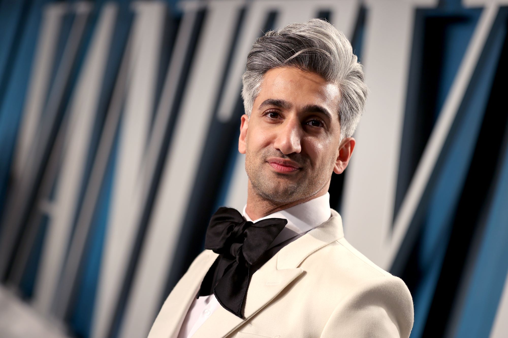 Tan France in a white suit at a Vanity Fair Oscar Party