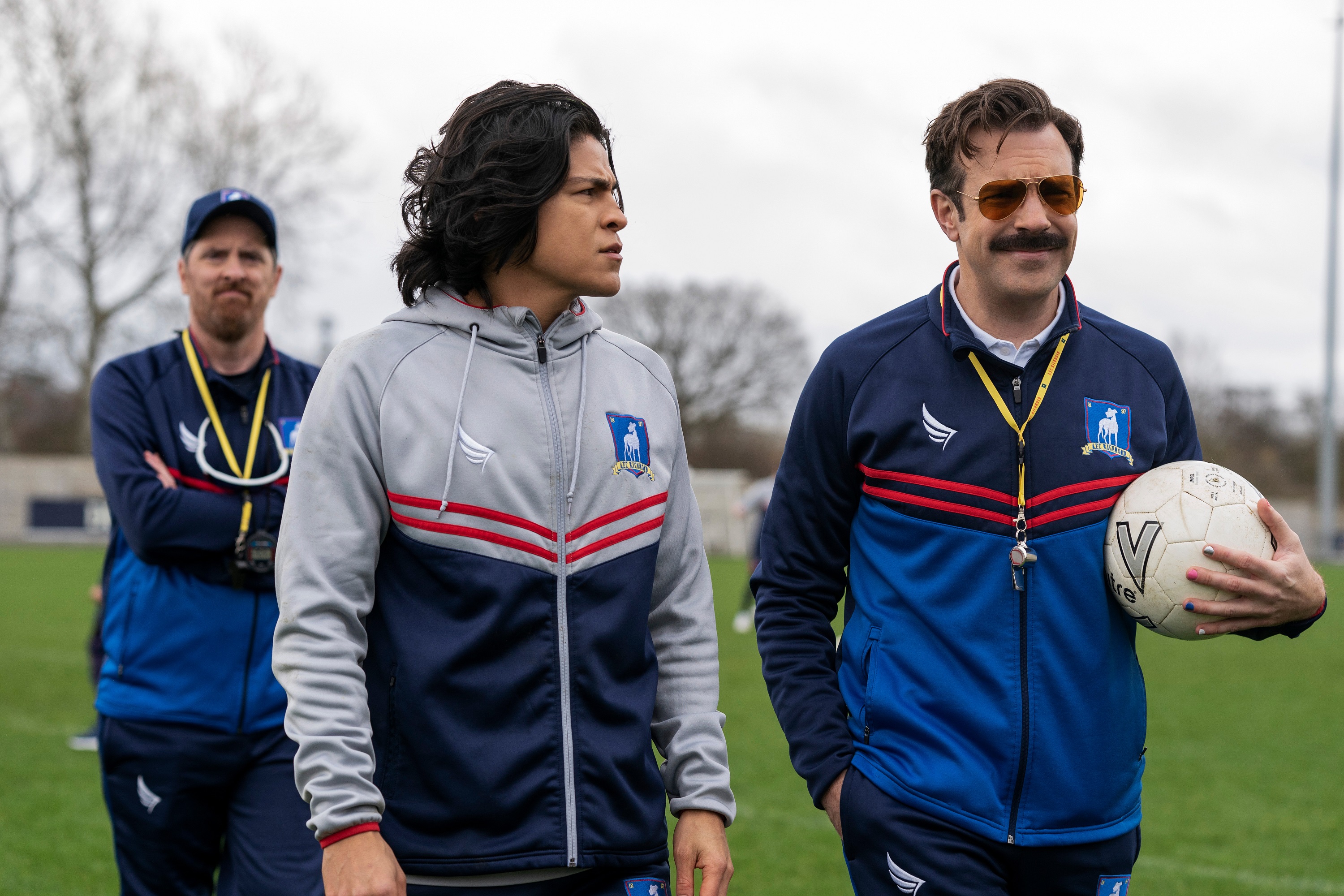 Brendan Hunt walks behind Cristo Fernández and Jason Sudeikis in a scene from 'Ted Lasso'