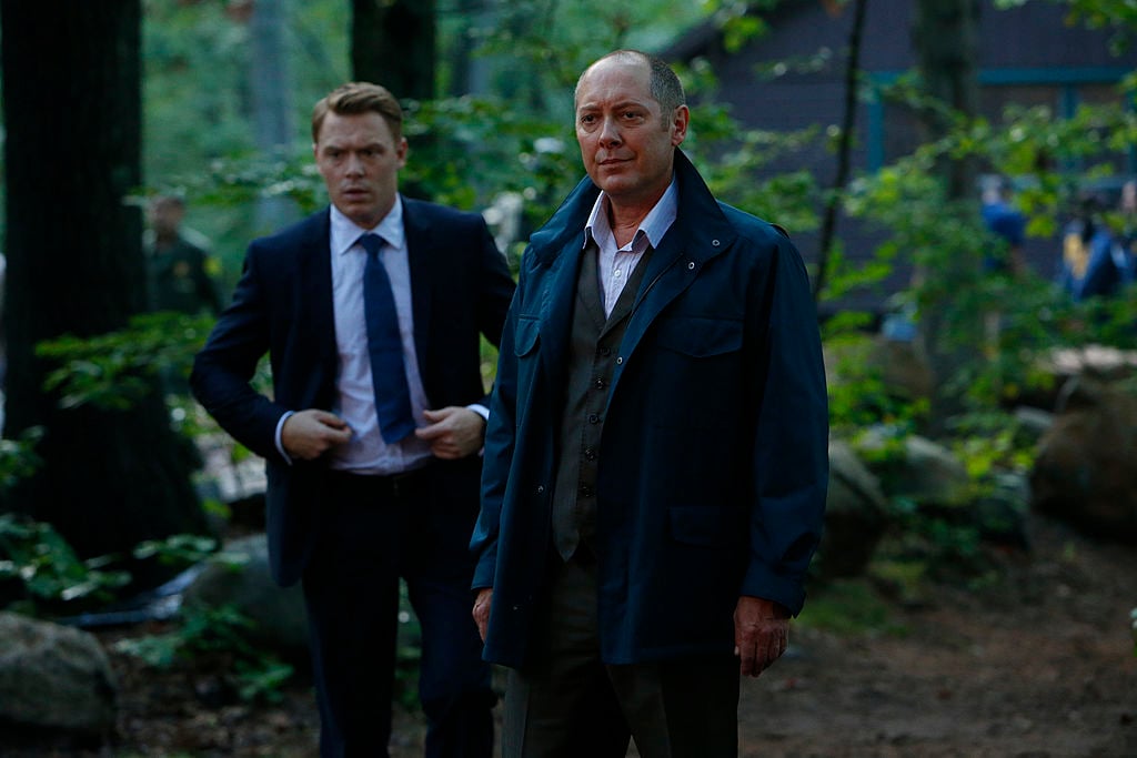 Diego Klattenhoff as Donald Ressler, James Spader as Raymond 'Red' Reddington stand in the woods overlooking a crime scene.