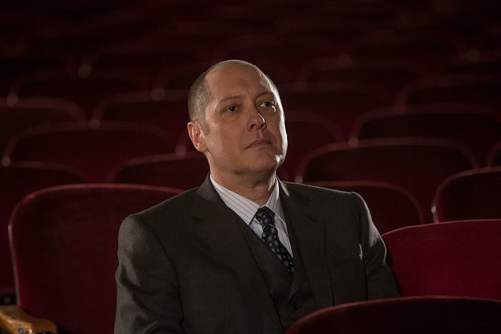 James Spader as Raymond 'Red' Reddington sits in a theater alone.