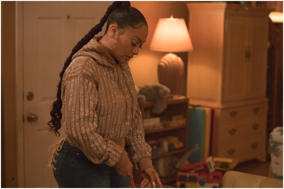 'The Chi' and 'Power' actor La La Anthony looking down while wearing a sweater and jeans.