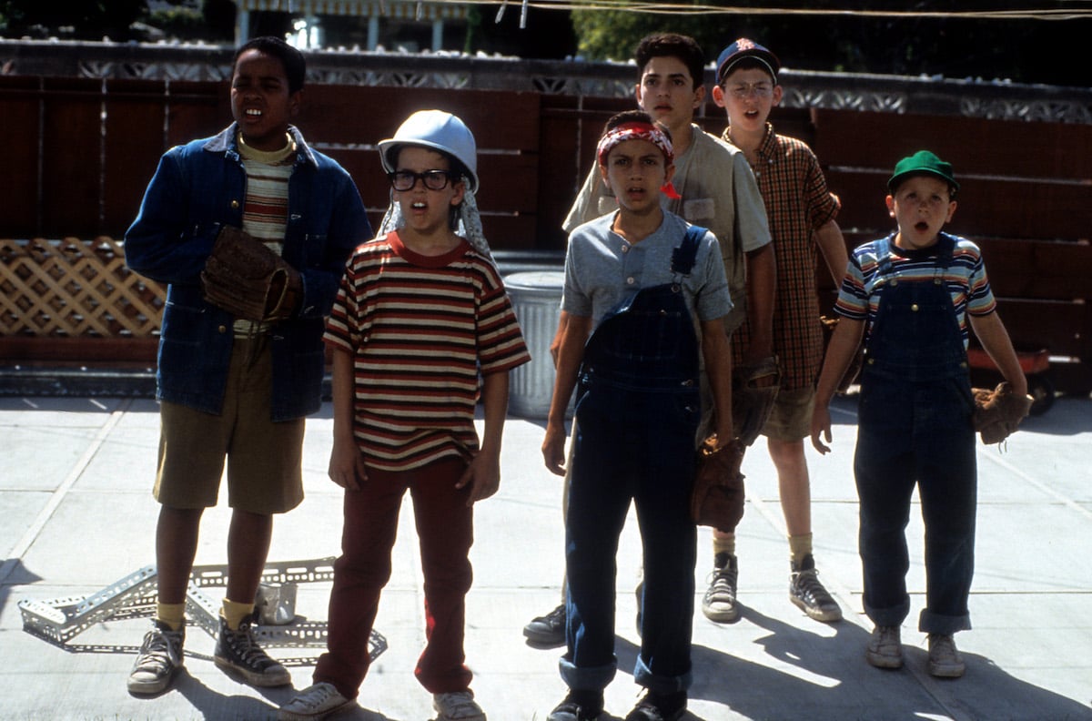 Brandon Quintin Adams as Kenny DeNunez, Chauncey Leopardi as Michael 'Squints' Palledorous, Patrick Renna as Hamilton 'Ham' Porter, Mike Vitar as Benjamin Franklin Rodriguez, Tom Guiry as Scotty Smalls, Art LaFleur as The Babe stand outside looking shocked in 'The Sandlot'