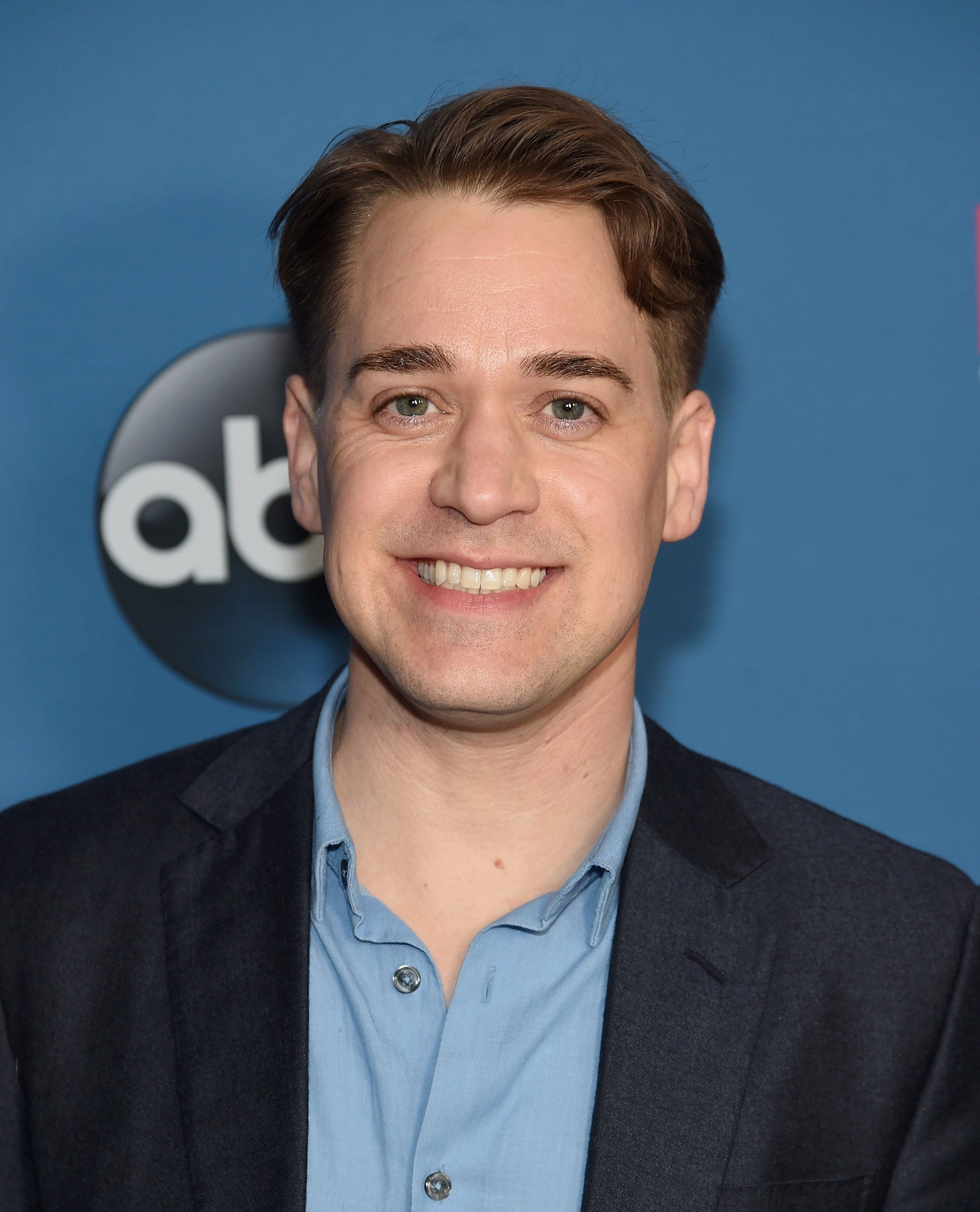 Theodore Raymond 'T.R.' Knight attending an ABC event while wearing a blue shirt and black blazer.