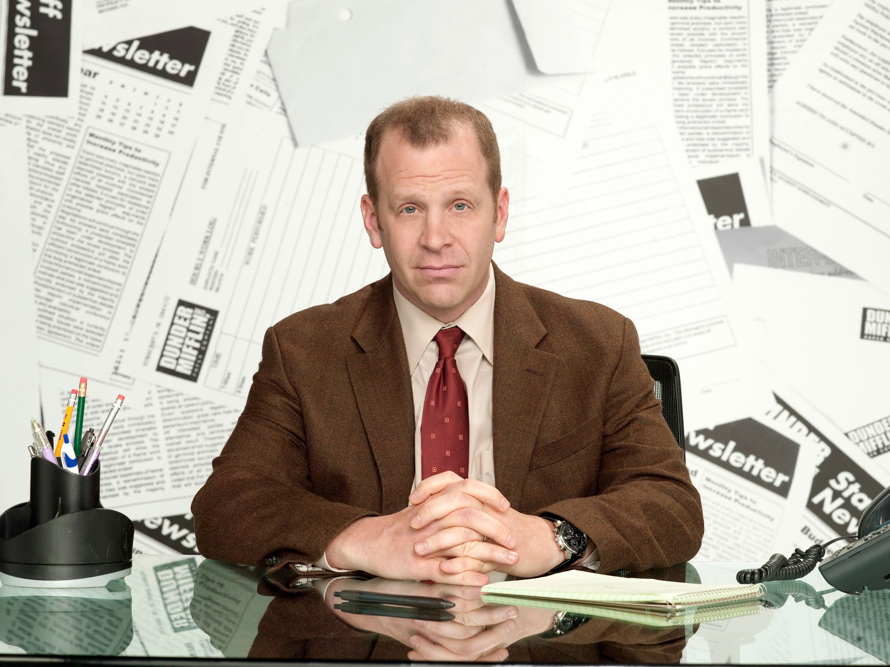 Paul Lieberstein as Toby Flenderson, sitting at his desk in 'The Office.'