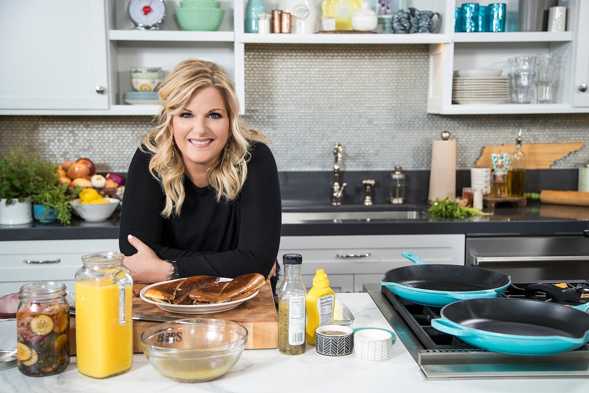 Trisha Yearwood smiles as she stands in the kitchen on the set of 'Trisha's Southern Kitchen'
