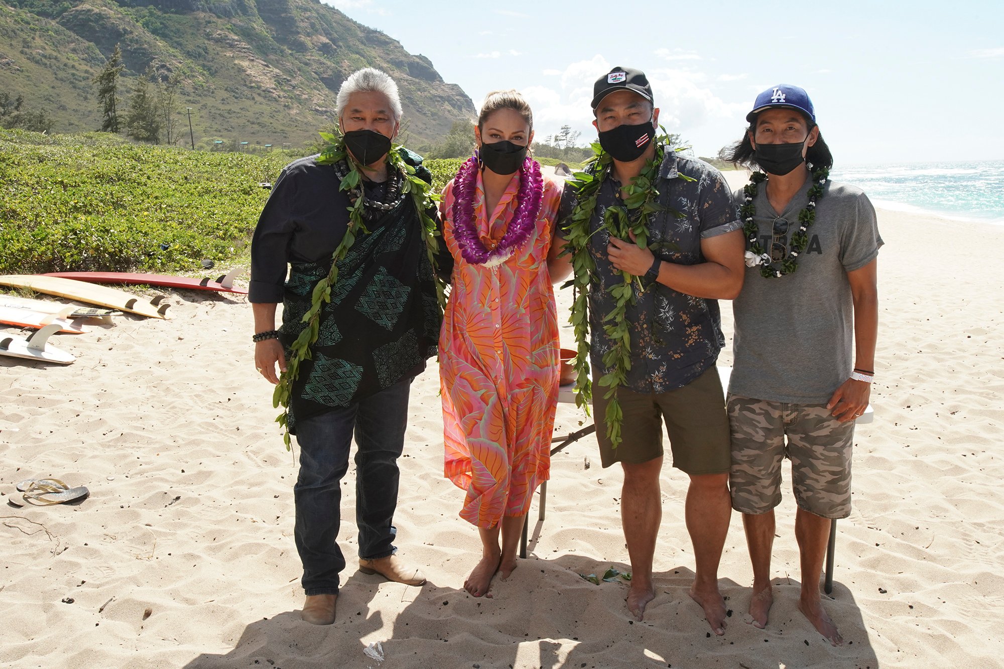 NCIS: HAWAIʹI kicked off its first season production at Mokulē‘ia Beach on Oahu with a traditional Hawaiian blessing in honor of its host Hawaiian culture, which was held in line with the series’ overall filming safety protocols. Series stars Vanessa Lachey, Noah Mills, Jason Antoon, Yasmine Al-Bustami and Tori Anderson, as well as the producers and the NCIS: HAWAIʹI crew, participated. Kahu (Officiant) Kordell Kekoa officiated the ceremony, which included traditional royal maile leis, Oli Aloha (welcoming chant), and Pule Ho’oku’u (closing prayer). In honor of the show’s premiere season, the ceremony centered on the constant motion of the ocean and how the moving ocean waters, driven by the winds and tides, connects the entire planet. Pictured L-R: Kahu (Officiant) Ramsey Taum presides over the blessing ceremony, Vanessa Lachey, Executive Producer / Director Larry Teng, and Director of Photography Yasu Tanida Photo: Karen Neal/CBS ©2021 CBS Broadcasting, Inc