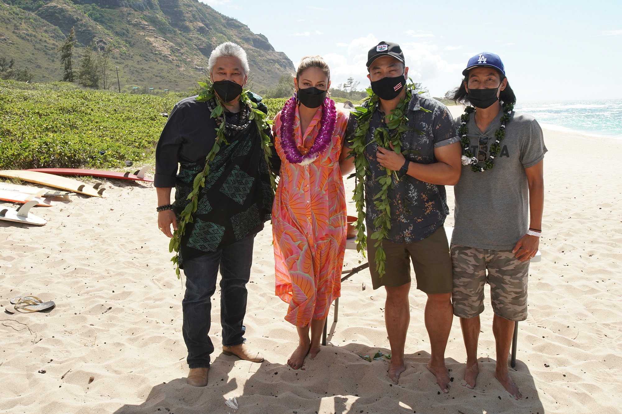 NCIS: HAWAIʹI kicked off its first season production at Mokulē‘ia Beach on Oahu with a traditional Hawaiian blessing in honor of its host Hawaiian culture, which was held in line with the series’ overall filming safety protocols. Series stars Vanessa Lachey, Noah Mills, Jason Antoon, Yasmine Al-Bustami and Tori Anderson, as well as the producers and the NCIS: HAWAIʹI crew, participated. Kahu (Officiant) Kordell Kekoa officiated the ceremony, which included traditional royal maile leis, Oli Aloha (welcoming chant), and Pule Ho’oku’u (closing prayer). In honor of the show’s premiere season, the ceremony centered on the constant motion of the ocean and how the moving ocean waters, driven by the winds and tides, connects the entire planet.  Pictured L-R: Kahu (Officiant) Ramsey Taum presides over the blessing ceremony,  Vanessa Lachey, Executive Producer / Director Larry Teng,  and Director of Photography Yasu Tanida Photo: Karen Neal/CBS ©2021 CBS Broadcasting, Inc