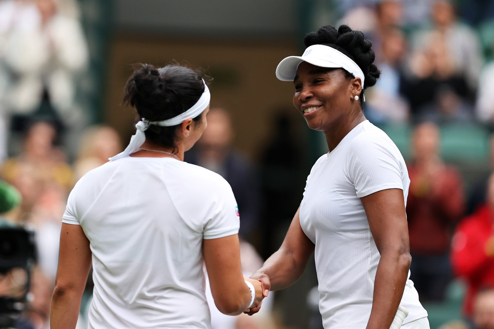 Venus Williams and Ons Jabeur shake hands at the net after their match 