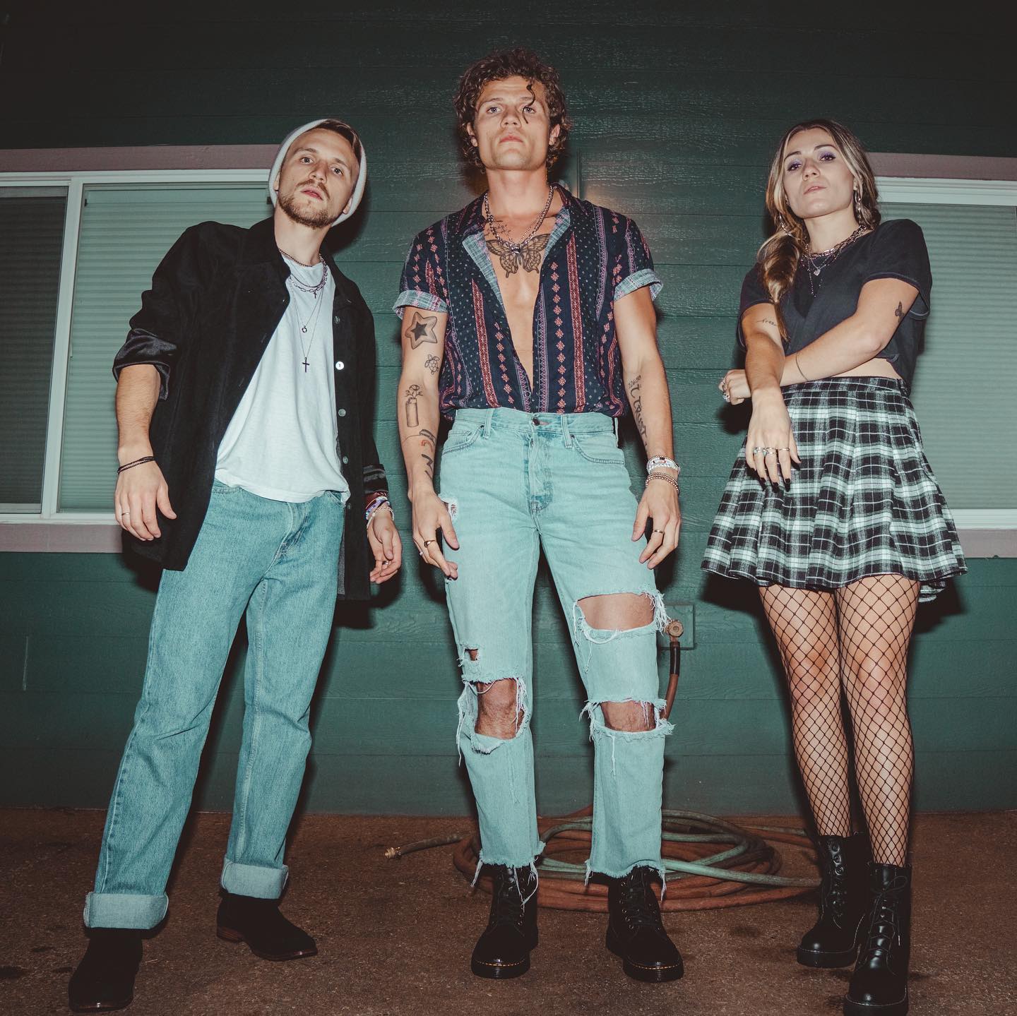 Joshua, Manny, and Bethany Humlie of the band We Three pose for a promotional photo