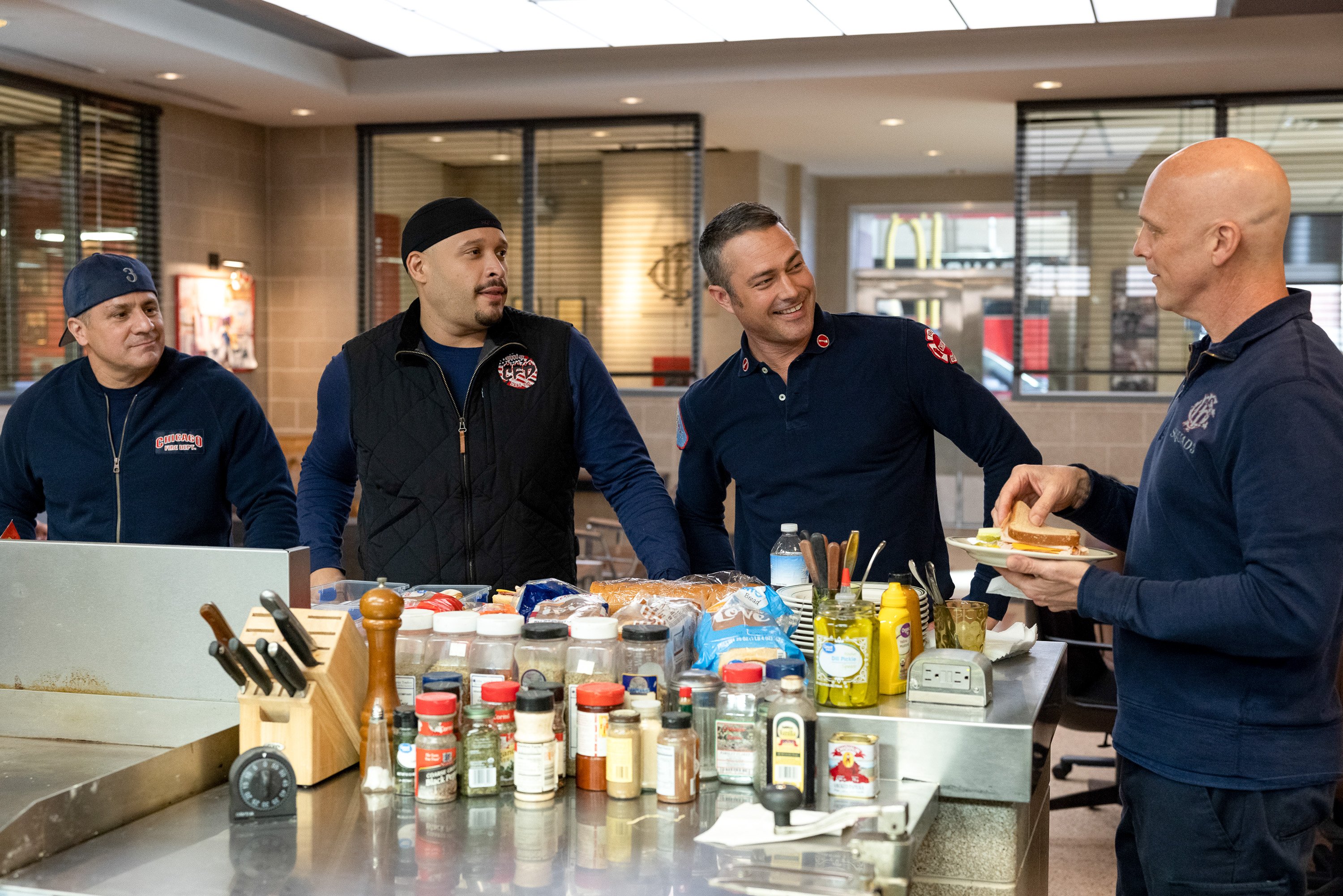 Chicago Fire cast stands in the kitchen