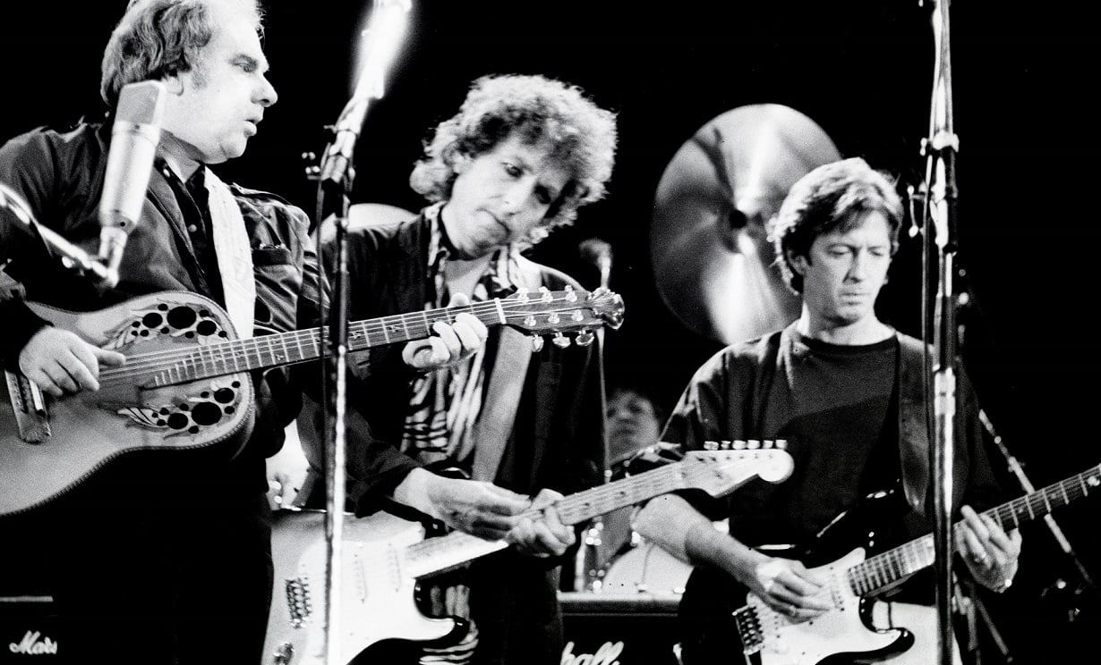 Van Morrison, Bob Dylan, and Eric Clapton performing on stage