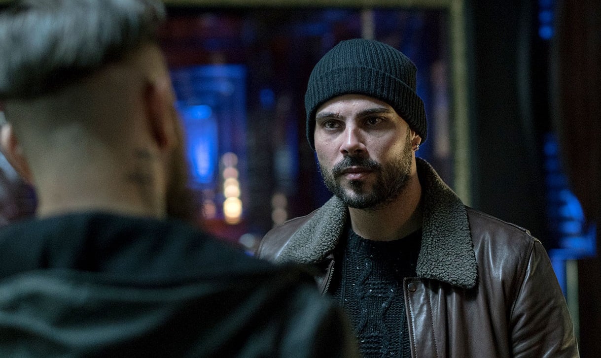 Marco D'Amore looks intently at a another character, whose back is in the photo's view, in a scene from 'Gomorrah.'