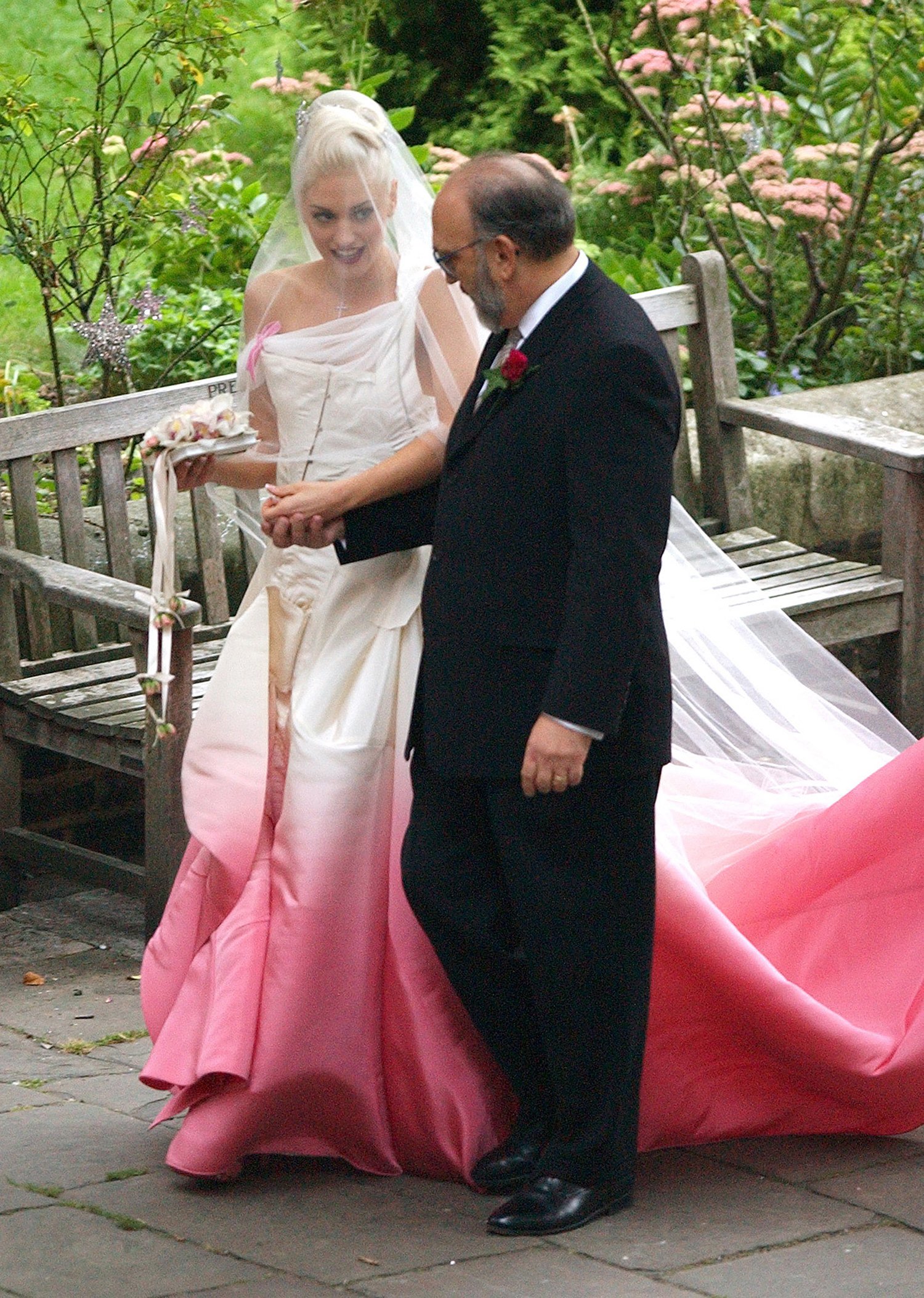 Gwen Stefani holds hands with her father during her wedding ceremony with Gavin Rossdale in 2002..