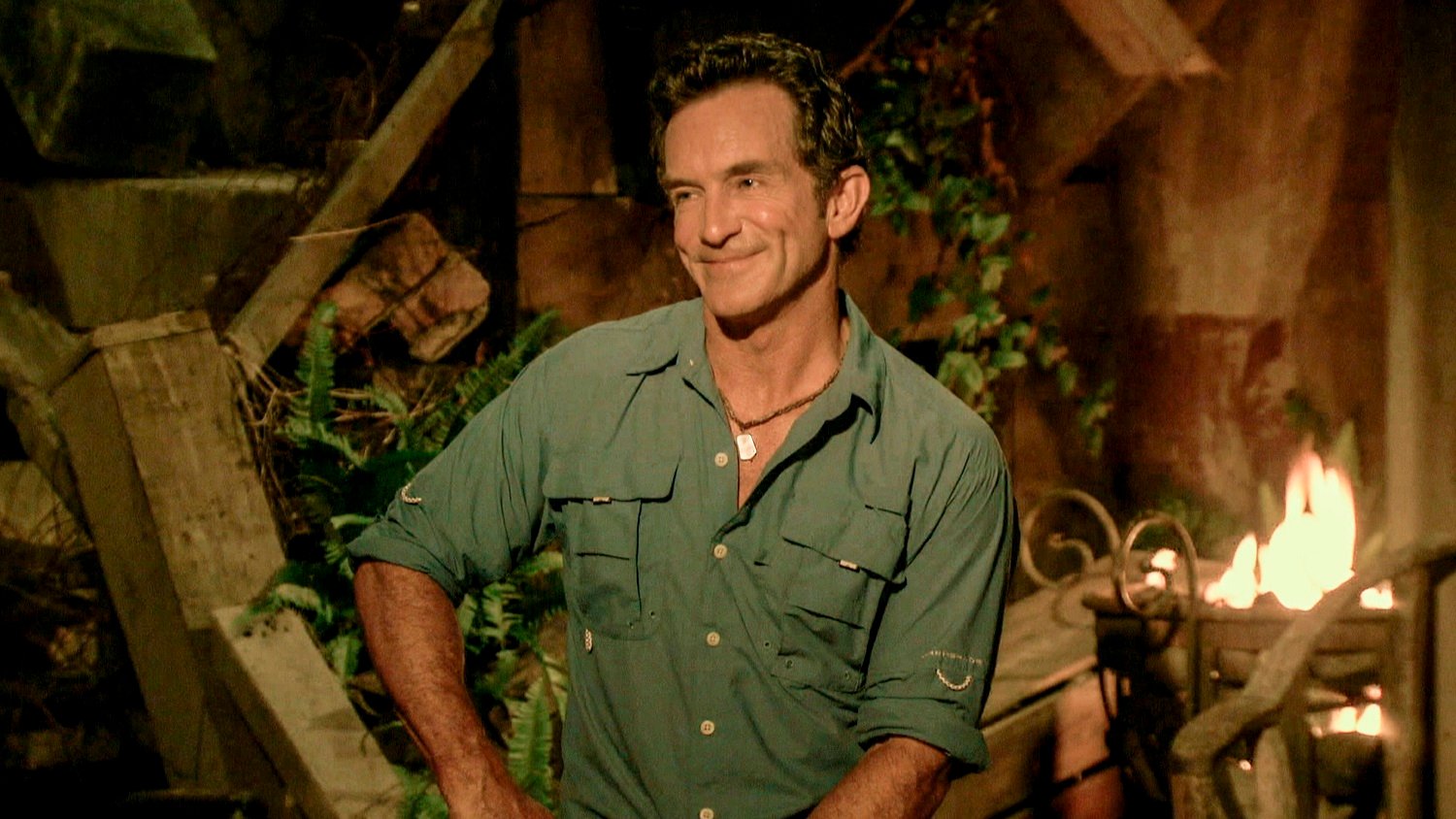 Jeff Probst, host of 'Survivor 41' sits and smiles during tribal council