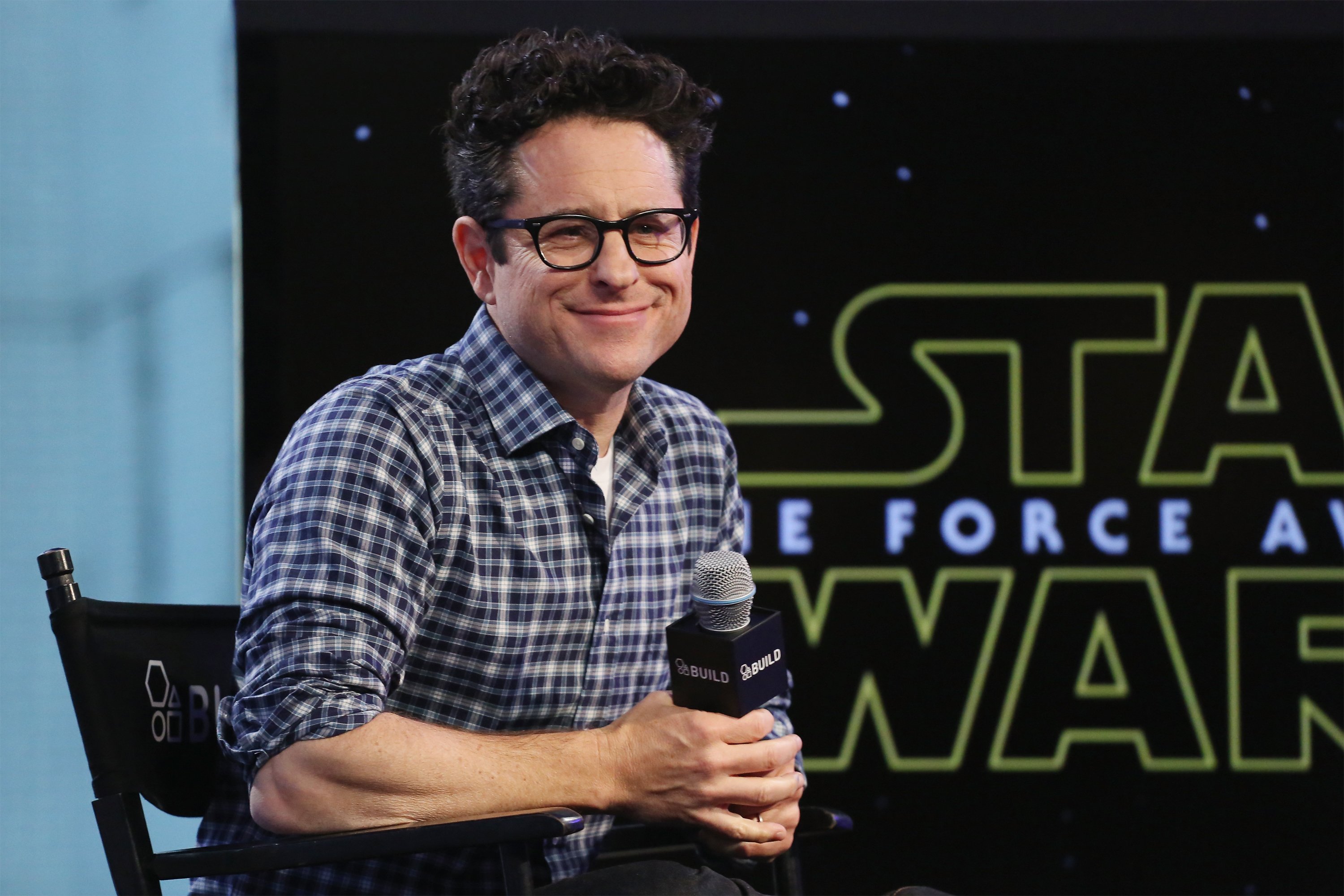 J. J. Abrams near a Star Wars logo