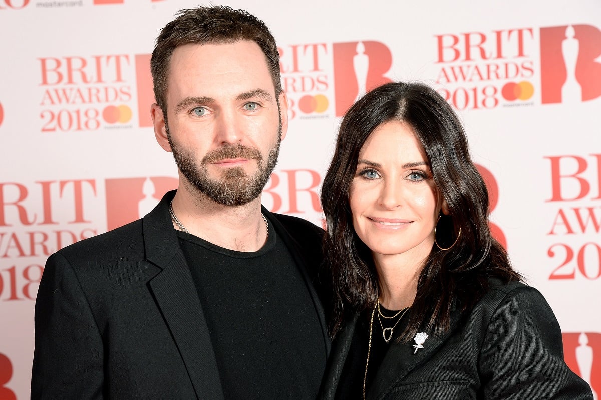 Johnny McDaid (L) and Courteney Cox attend The BRIT Awards 2018 on February 21, 2018, in London, England.
