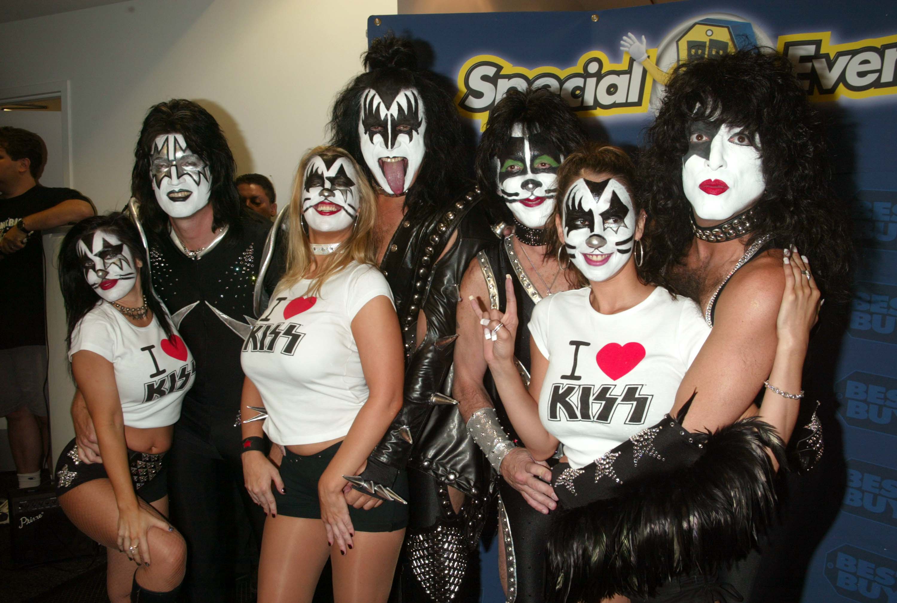 Tommy Thayer, Gene Simmons, Peter Criss and Paul Stanley of Kiss with fans in makeup