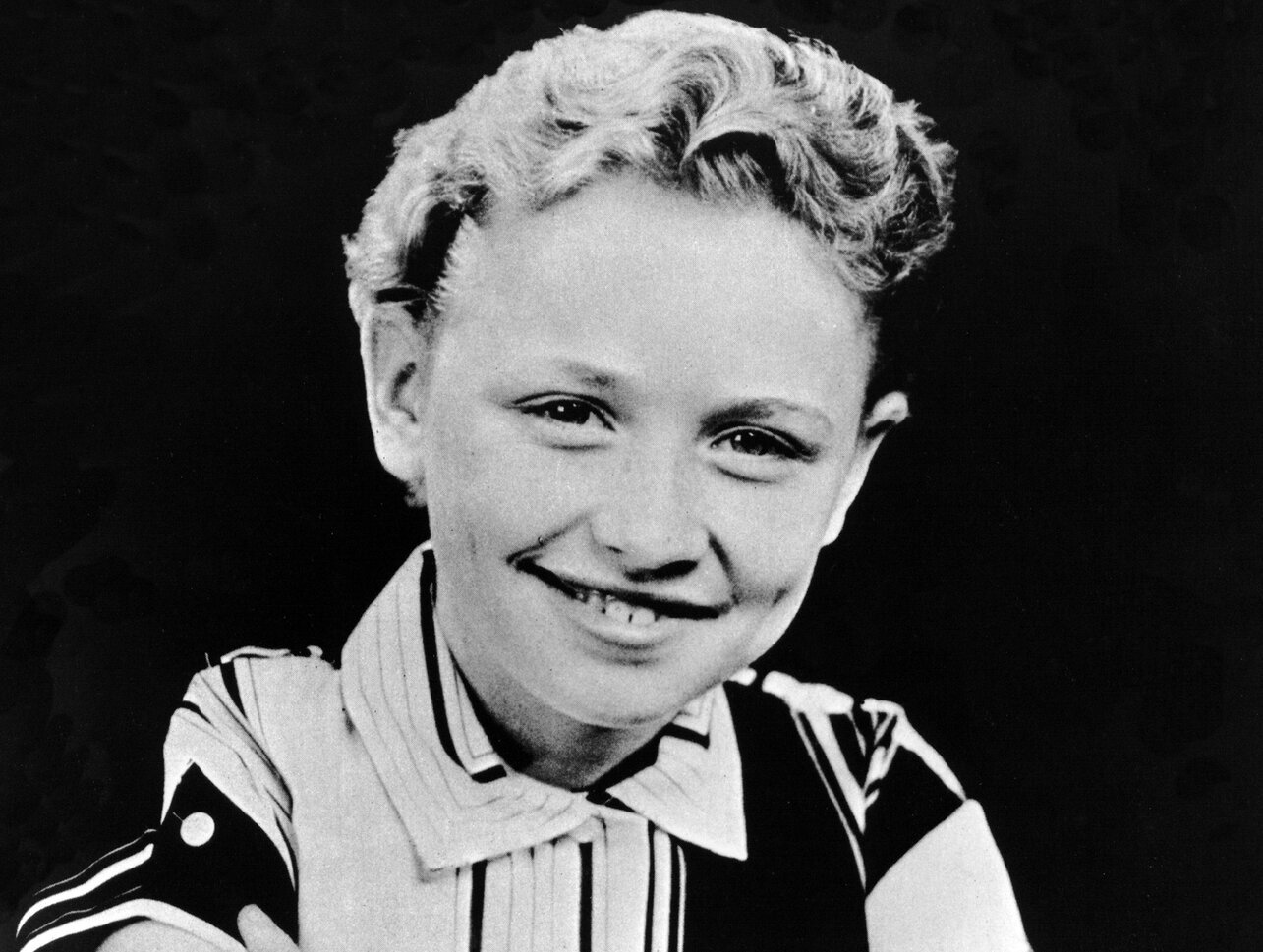 Dolly Parton as a child, photographed in black and white in 1955.