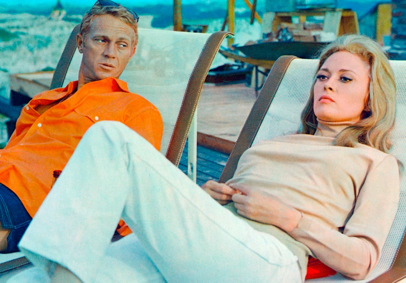 Steve McQueen and Faye Dunaway relax on the set of 'The Thomas Crown Affair', circa 1968.