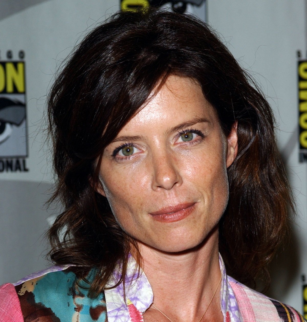Torri Higginson smiles and poses for a photograph while at an event.