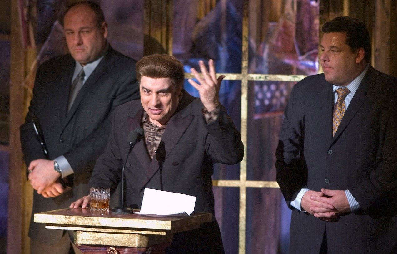 Steven Van Zandt in character as Silvio Dante speaks during the Rock and Roll Hall of Fame Induction Ceremony in 2005. James Gandolfini and Steve Schirripa stand behind him.