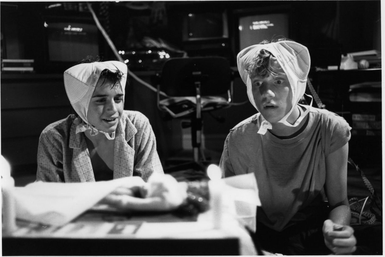 Ilan Mitchell-Smith and Anthony Michael Hall wear bras on their heads in a scene for 'Weird Science'