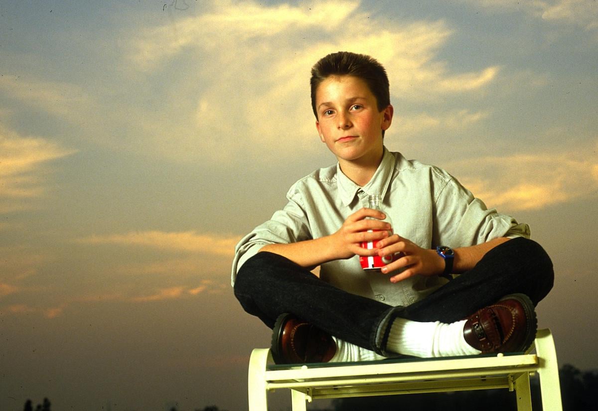 13-year-old Christian Bale poses on a chair to promote ‘Empire of the Sun’