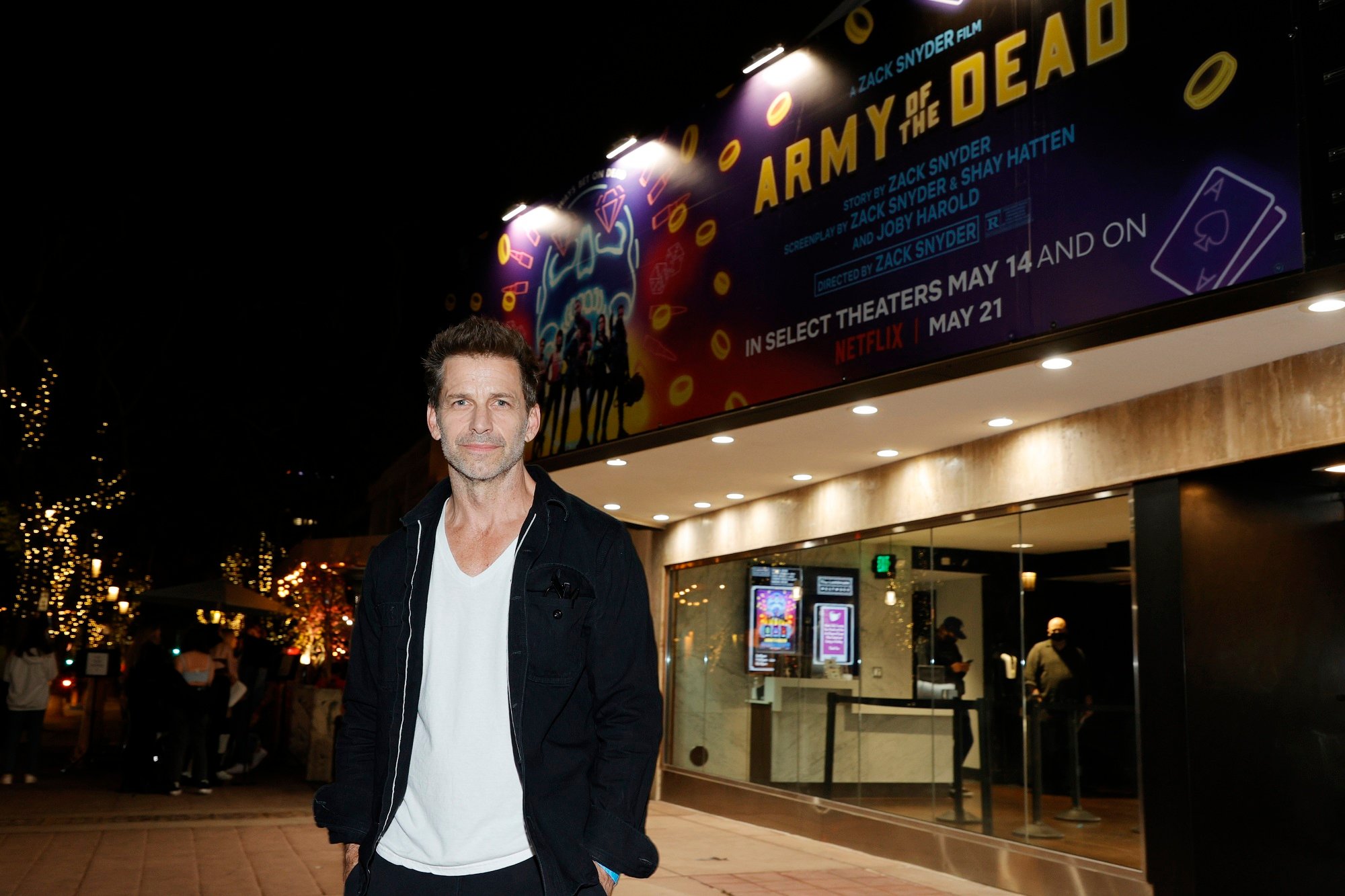 Zack Snyder standing outside a theater showing one of his films