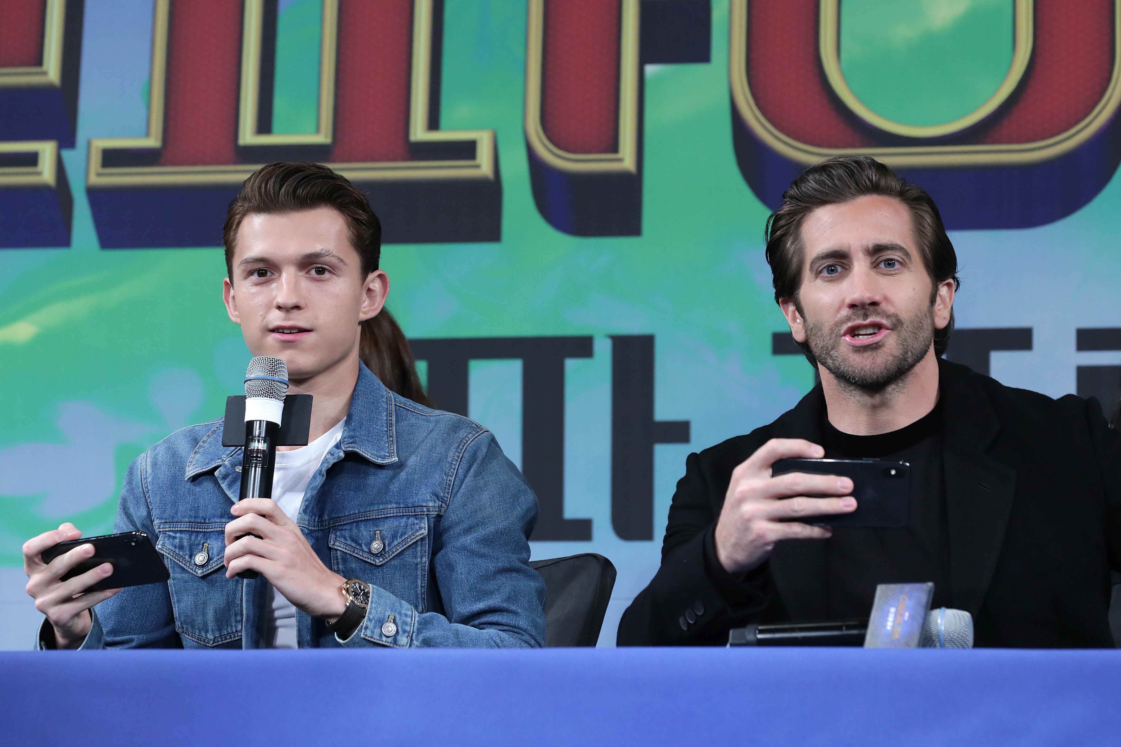 Tom Holland and Jake Gyllenhaal talking at press conference