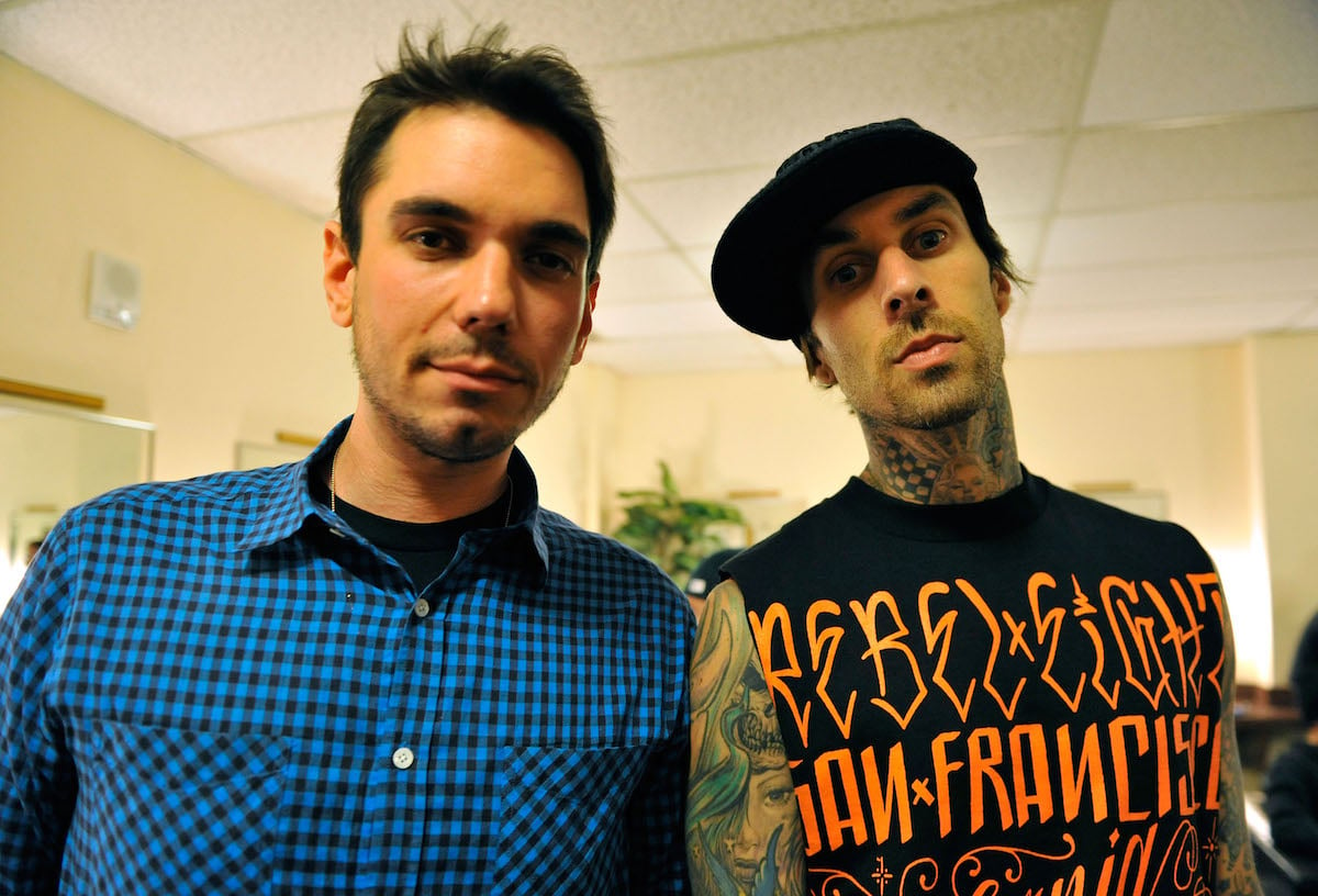 Adam Goldstein, also known as DJ AM, and friend Travis Barker face the camera, unsmiling.