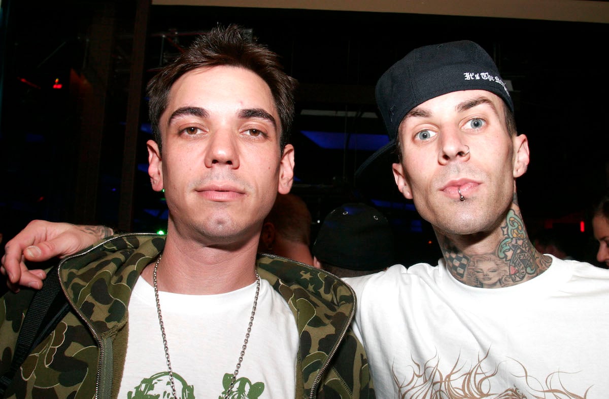 Travis Barker puts one arm around friend DJ AM.