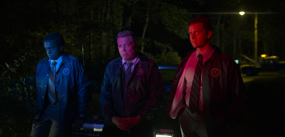 Albert Jones, Holt McCallany, and Jonathan Groff are lit by red and blue police lights in 'Mindhunter.'