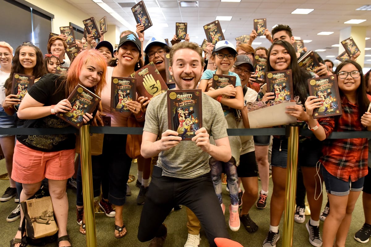 Alex Hirsch poses with fans at 'Gravity Falls' book signing.