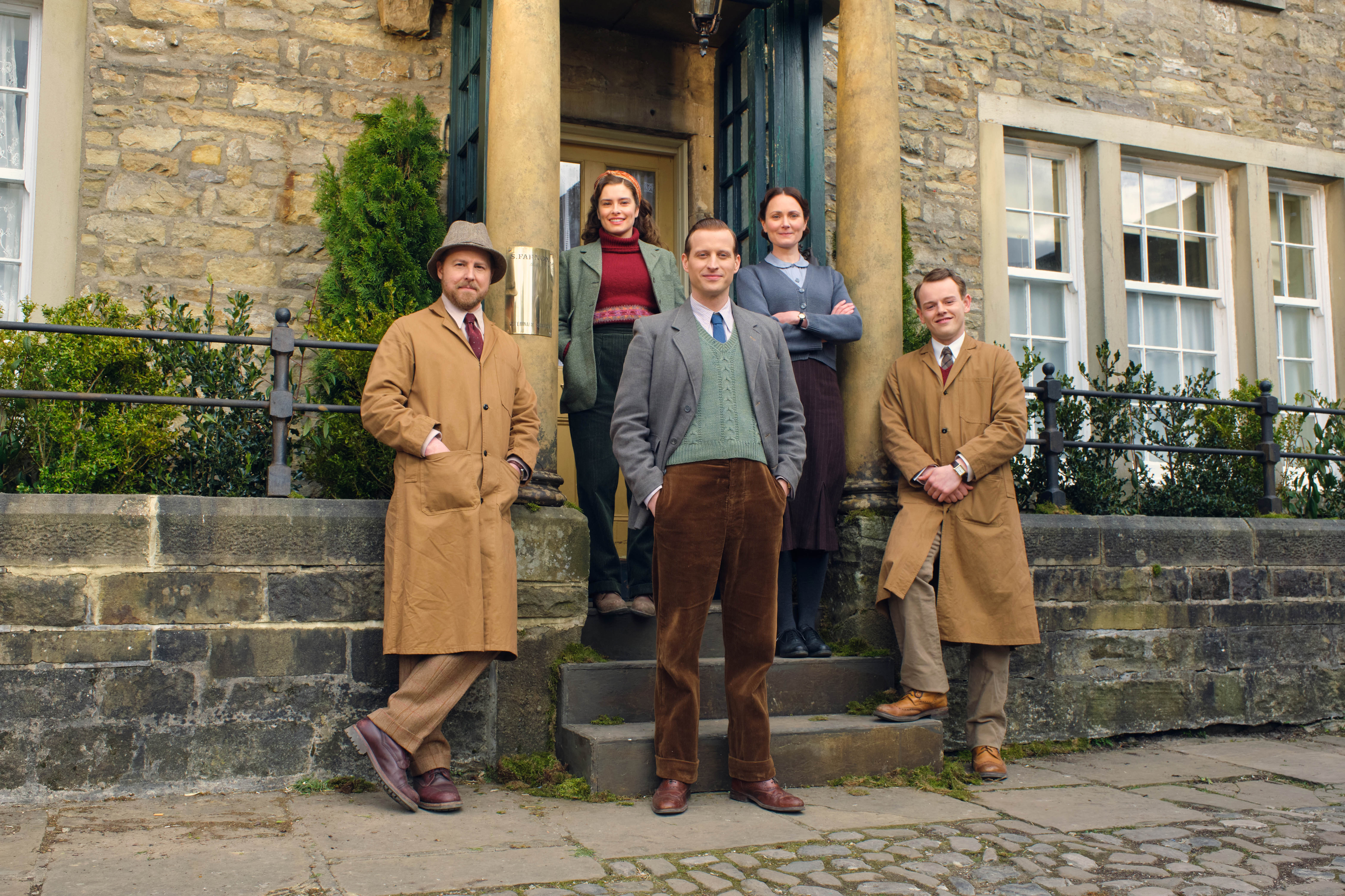 Cast of 'All Creatures Great and Small' Season 2 standing outside a house