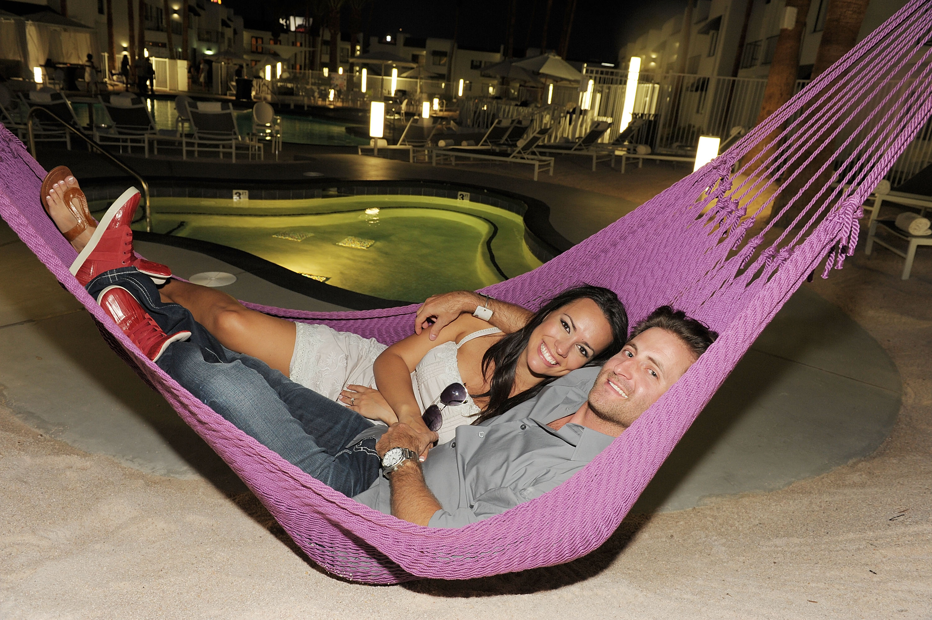 Ann Lueders and Jesse Csincsak in a pink hammock.