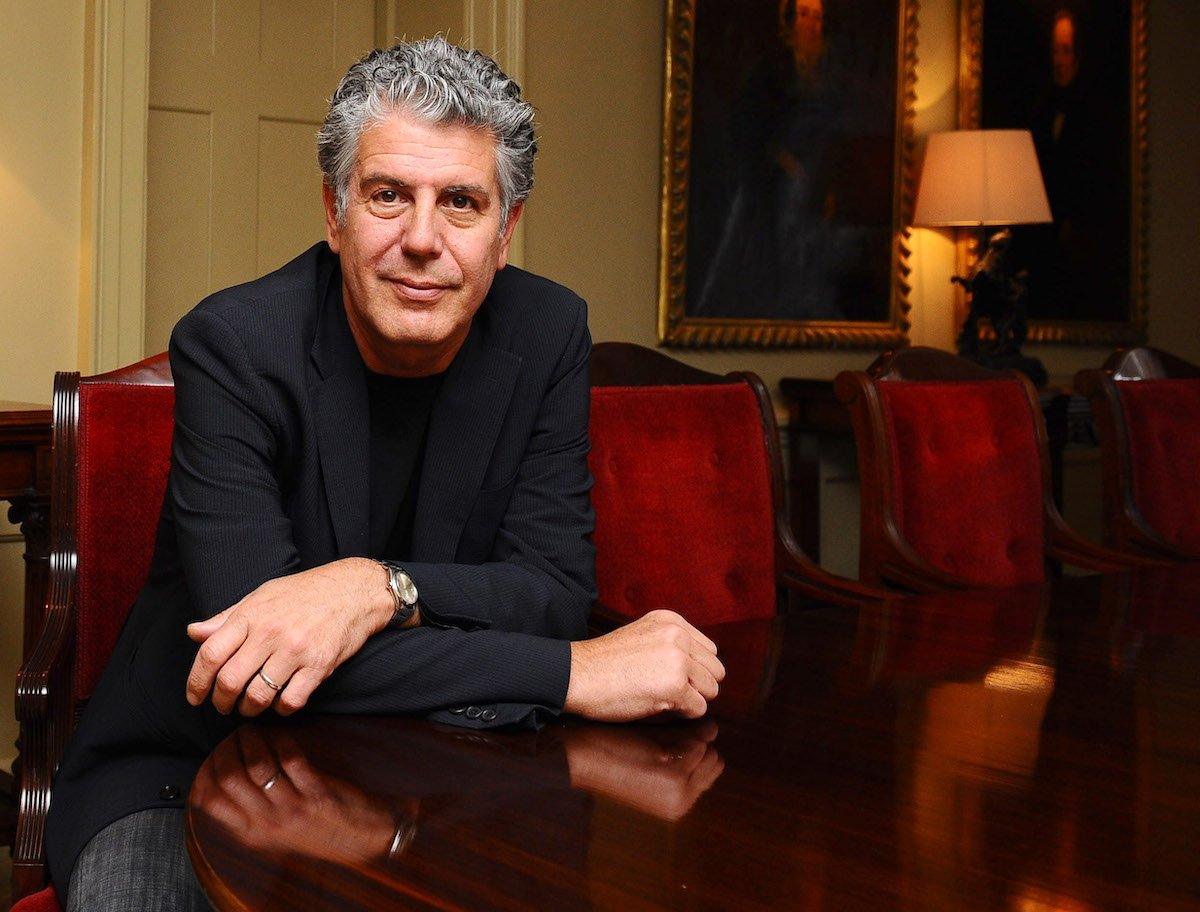 Anthony Bourdain sitting at a table