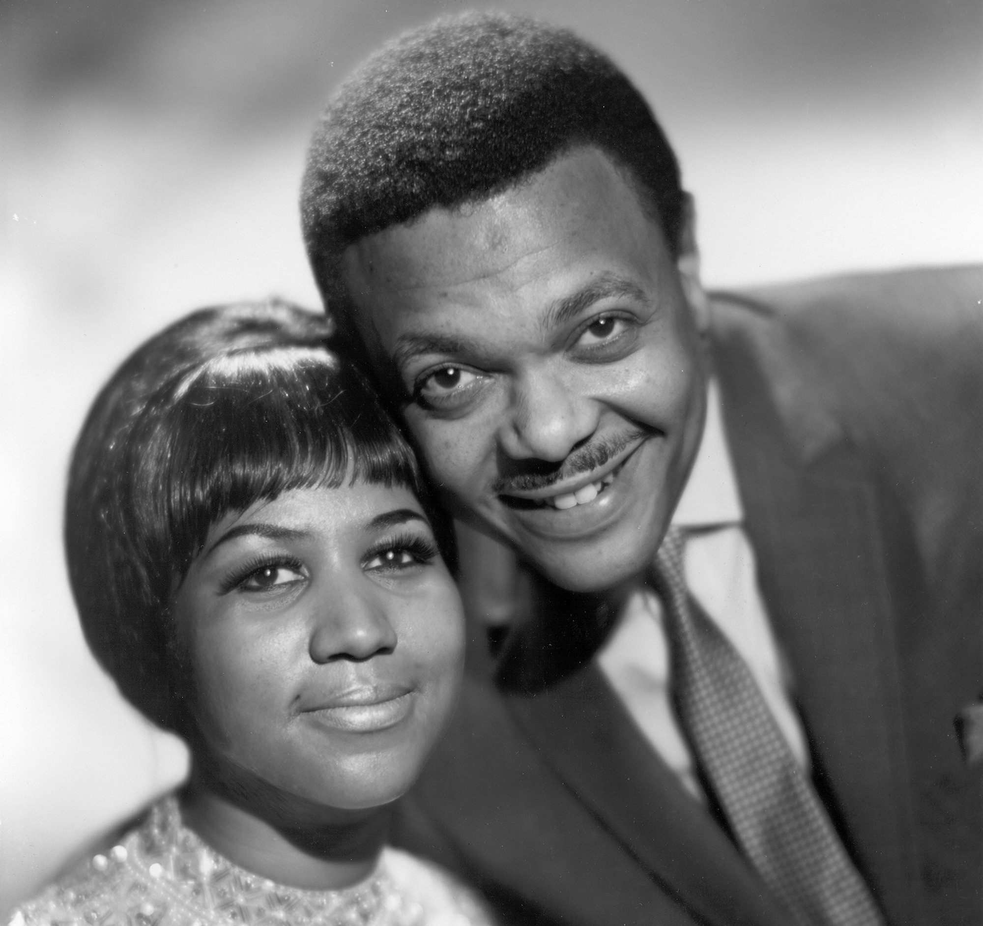 A portrait of Aretha Franklin posing with her first husband/ manager Ted White