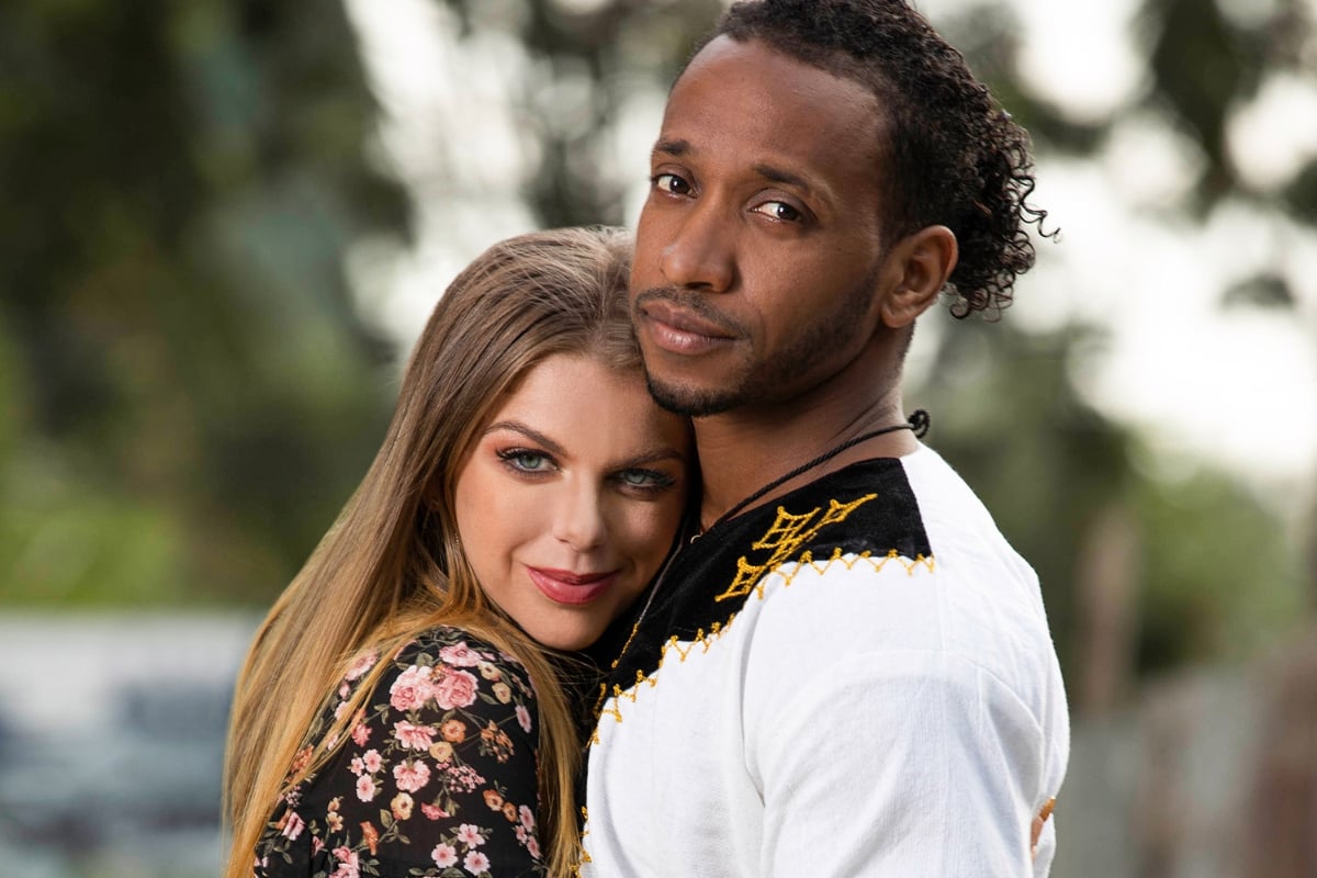 Ariela and Biniyam on ’90 Day Fiancé’, Ariela Danielle rests her head on Biniyam Shibre's chest as they look at the camera