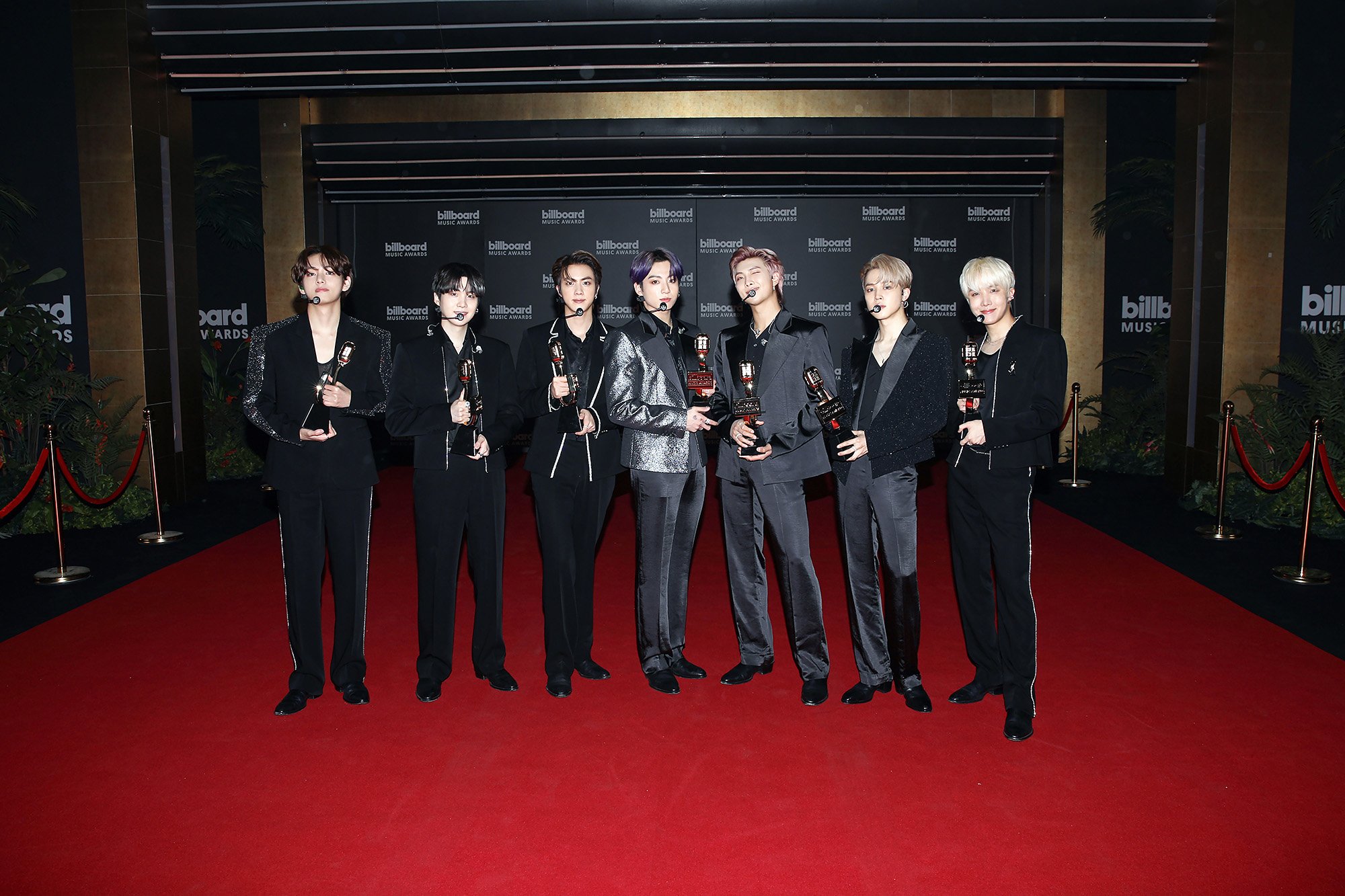 V, Suga, Jin, Jungkook, RM, Jimin, and J-Hope of BTS pose for the 2021 Billboard Music Awards