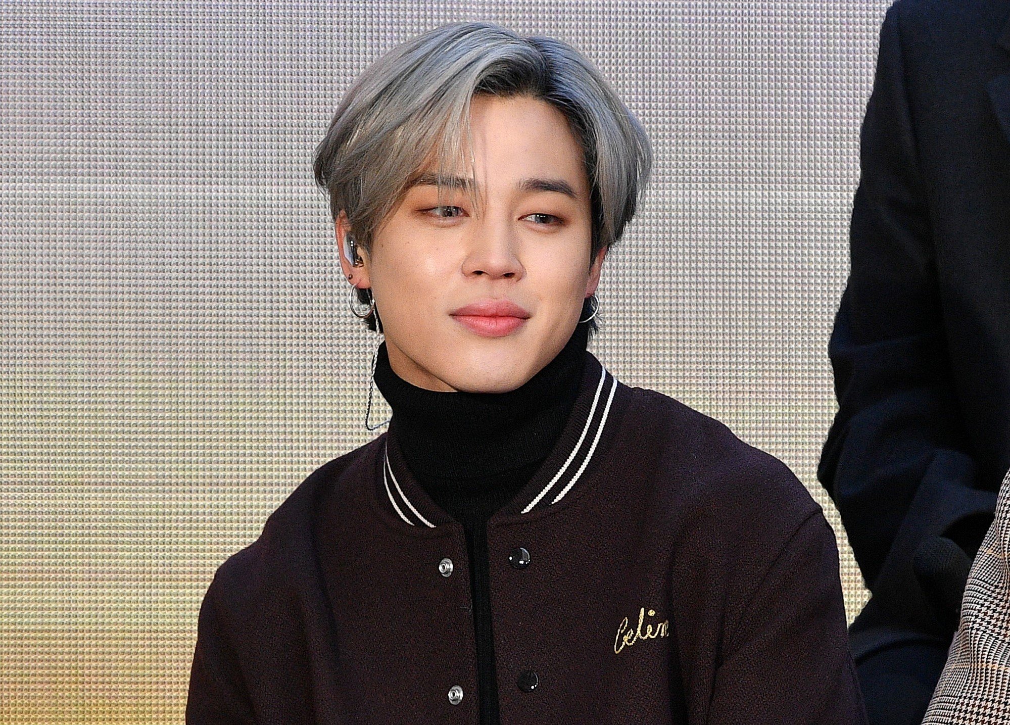 Jimin of BTS sits on stage at the 'Today' Show at Rockefeller Plaza