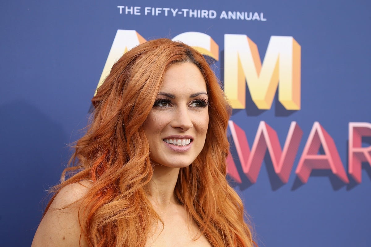 WWE star Becky Lynch wears a white dress at the 2018 Academy of Country Music Awards in Las Vegas.