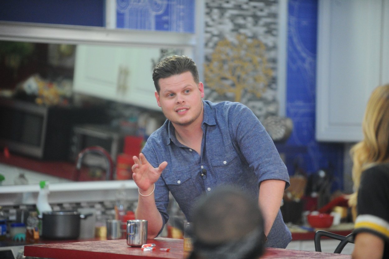 Former champ Derrick Levasseur in kitchen while talking to 'Big Brother 19' houseguests