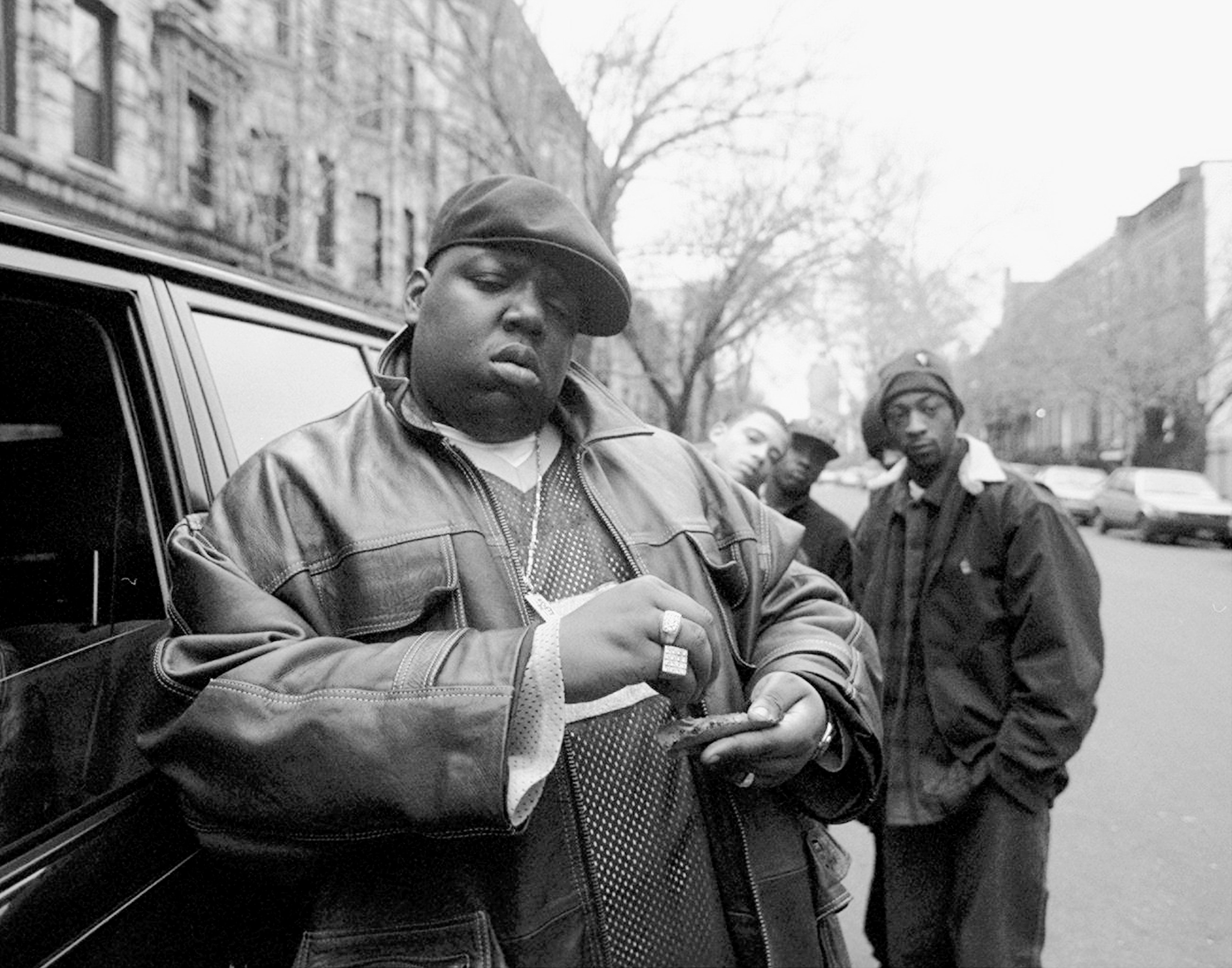 The Notorious B.I.G., aka Biggie Smalls rolls a cigar outside his mother's house in Brooklyn, New York,