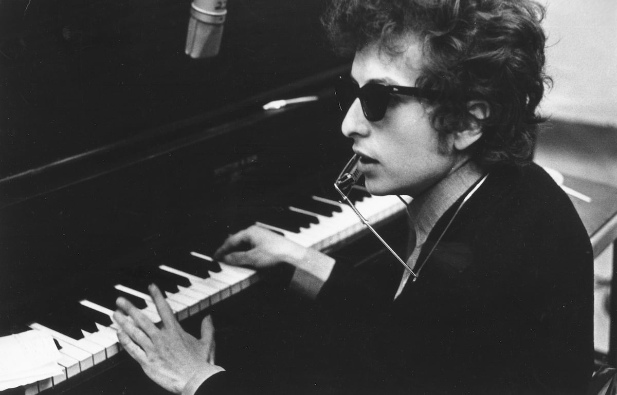 Bob Dylan in sunglasses at piano